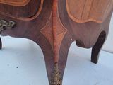 a wooden cabinet that has a design on it