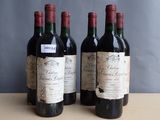 three bottles of wine sitting on top of a table next to each other