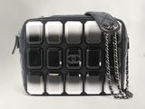 a black and white bag with a chain on it