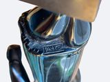 a close up of a metal object with a knife in it