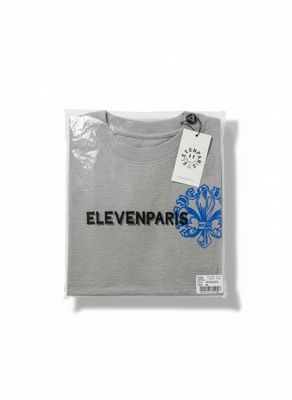 a grey t - shirt with a blue flower on the front