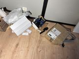 a cardboard box on the floor next to a pair of scissors and a pair of scissors