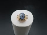 an image of a ring with a blue stone in it