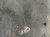 a silver plate with a bike on it on a table