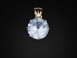 a gold pendant with a blue topaz stone on a black background
