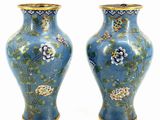 pair of blue vases with flowers and birds on them on a white background