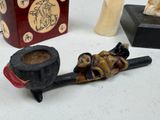 a small pipe and a pipe holder on a table