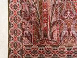 an image of a red and pink rug with a floral design