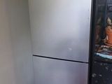 an image of a refrigerator in a kitchen with a red floor