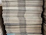 a stack of newspapers stacked on top of each other in a room