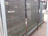 a fence that has a sign on it in front of it
