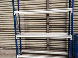 a blue and white shelf in front of a garage door