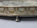 a silver tray that has a mirror on top of it