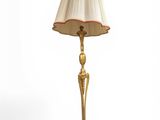 une image représentant une lampe dorée surmontée d'un abat-jour blanc