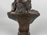 a bronze bust of a bearded man on a pedestal
