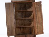 a wooden cabinet with a door open on a white surface