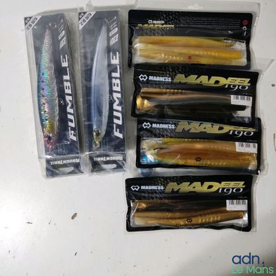 several fishing lures are lined up on a counter top