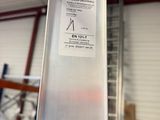 a metal pole with a sticker on it in a warehouse