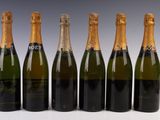six bottles of champagne are lined up in a row