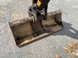 a small excavator that is sitting on the ground