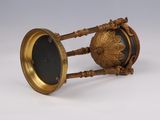 a gold clock with a black face on it