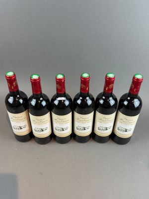 six bottles of wine lined up in a row on a table