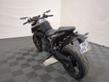 a picture of a black motorcycle parked on a checkered floor