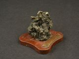 a small piece of rock on a small wooden stand
