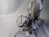 a statue of a bird that is sitting on top of a rock