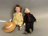 two dolls sitting next to each other on the floor