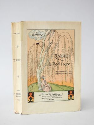 an old book with a picture of a woman sitting under a tree