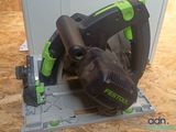 a picture of a green and black circular saw on a piece of plywood