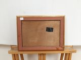 an image of a picture frame sitting on top of a wooden stand