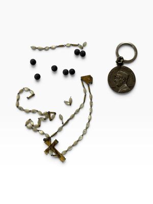 an image of a necklace, earring, and a coin on a white surface