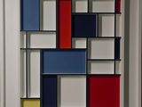framed artwork of a colorful abstract painting of squares and rectangles in a white frame