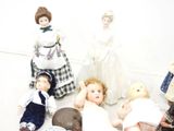 a lot of dolls that are sitting on the floor