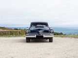 a black car that is parked on the side of the road