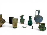 many different vases that are sitting on a white surface