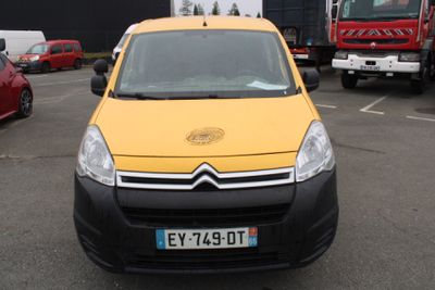 une camionnette jaune garée sur un parking à côté d'un camion rouge