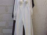 a white dress on a mannequin stand in a room