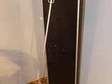 a mirror on a stand in the corner of a room
