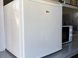 a white refrigerator sitting on a counter in a kitchen