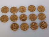 several gold coins are arranged in a row on a white surface