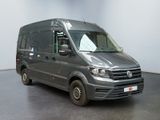 the grey van is parked in a white room with a black floor