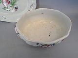 a bowl and plate sitting on a table next to each other