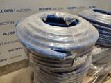 two rolls of hoses wrapped in plastic on a pallet