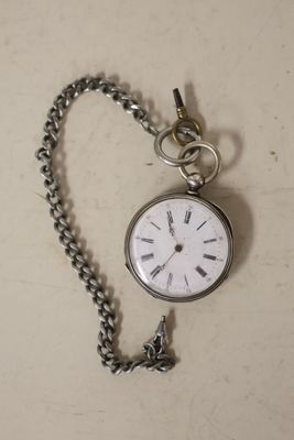 a silver pocket watch with a chain attached to it