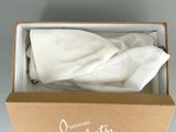 a box with a white cloth in it on a table