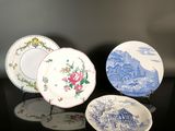 three plates with blue and white designs on them sitting on a table