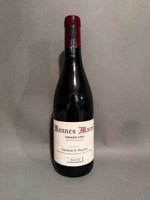 the bottle of wine is sitting on the table ready to be eaten